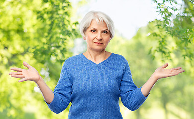 Image showing senior woman having no idea and shrugging