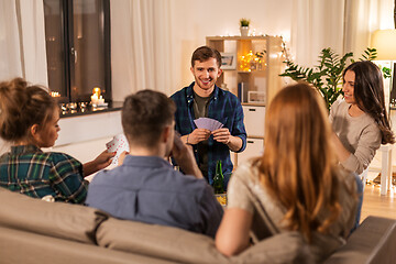 Image showing friends playing cards and drinking beer at home