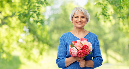 Image showing happy smiling senior woman with flowers