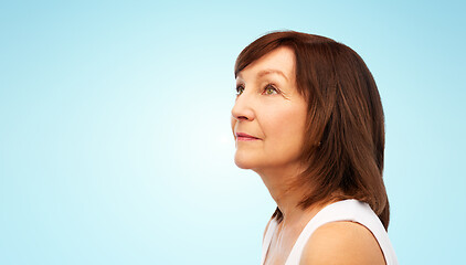 Image showing portrait of senior woman over blue background