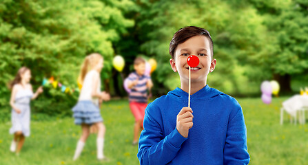 Image showing happy boy with red clown nose at birthday party