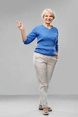 Image showing portrait of smiling senior woman in blue sweater