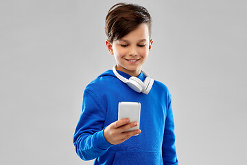 Image showing smiling boy in blue hoodie using smartphone