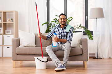 Image showing indian man with mop and detergent cleaning at home