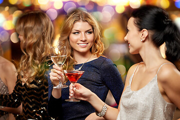 Image showing happy women clinking glasses at night club