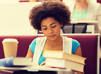 Image showing student girl with books and coffee on lecture