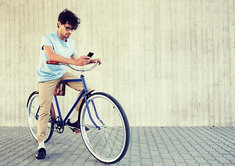 Image showing man with smartphone and fixed gear bike on street