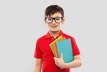 Image showing smiling schoolboy in glasses with books