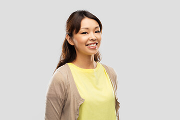 Image showing happy asian woman over grey background