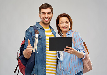 Image showing happy couple of tourists with tablet computer