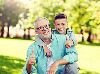 Image showing grandfather and boy showing thumbs up at summer