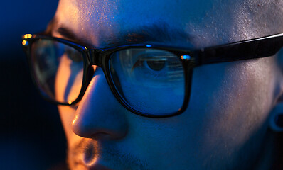 Image showing close up of hacker in glasses looking at screen