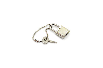 Image showing Small metallic padlock and key for bag or suitcase