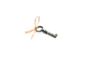 Image showing Vintage silver key with pink bow on white