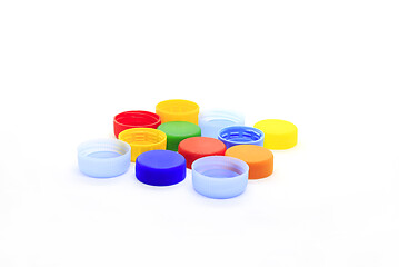 Image showing Multicolored caps from plastic bottles on white background