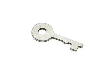 Image showing Simple metallic key on white background