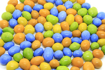 Image showing Multicolored glazed chocolate candies on a white