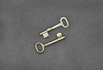 Image showing Two keys on gray paper background, close up