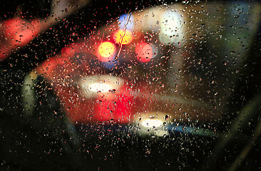 Image showing The lights of the night city through the glass with raindrops