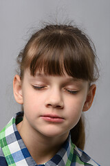 Image showing Portrait of a ten-year-old girl with closed eyes, European appearance, close-up