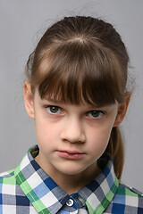 Image showing Portrait of a ten-year-old girl with a piercing look, European appearance, close-up