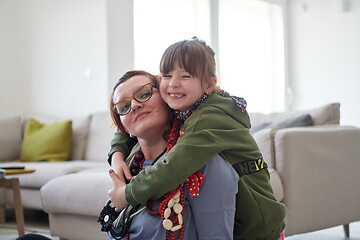 Image showing Mother and little girl daughter playing with jewelry  at home