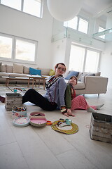 Image showing Mother and little girl daughter playing with jewelry  at home