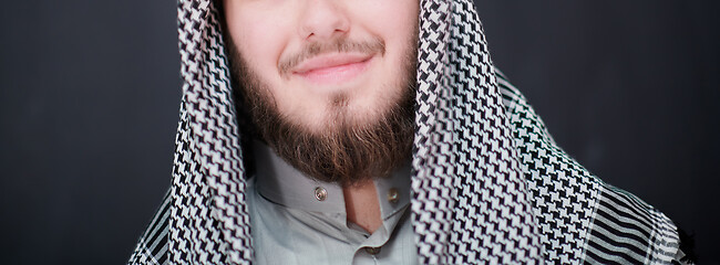 Image showing portrait of arabian man in front of black chalkboard