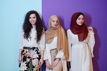 Image showing muslim women in fashionable dress isolated on colorful backgroun