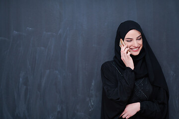 Image showing young modern muslim business woman using smartphone