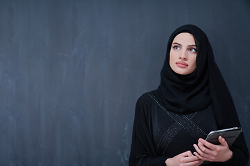 Image showing young modern muslim business woman using tablet computer