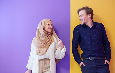 Image showing portrait of young muslim couple isolated on colorful background