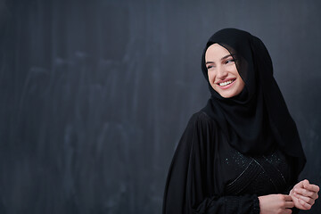 Image showing portrait of beautiful muslim woman in front of black chalkboard