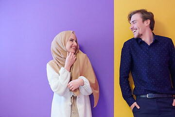 Image showing portrait of young muslim couple isolated on colorful background