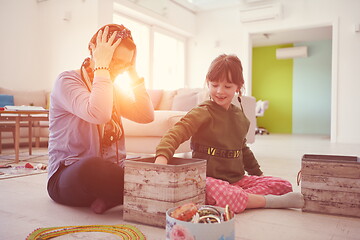 Image showing Mother and little girl daughter playing with jewelry  at home