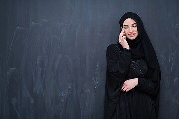 Image showing young modern muslim business woman using smartphone