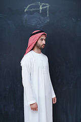 Image showing portrait of arabian man in front of black chalkboard