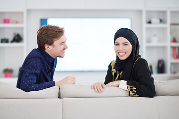 Image showing young muslim couple watching TV together