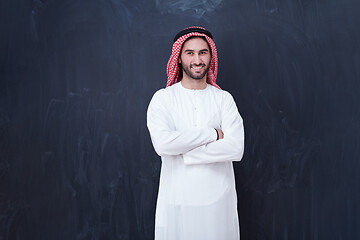 Image showing portrait of arabian man in front of black chalkboard