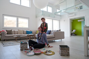 Image showing Mother and little girl daughter playing with jewelry  at home