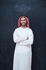 Image showing portrait of arabian man in front of black chalkboard