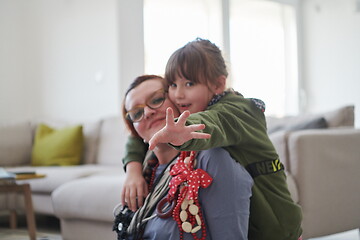 Image showing Mother and little girl daughter playing with jewelry  at home