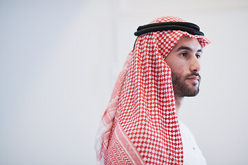 Image showing young arabian businessman using smartphone at home