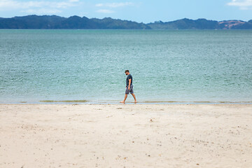 Image showing man walking alone at the beach New Zealand