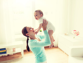 Image showing happy young mother with little baby at home