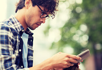 Image showing close up of man with tablet pc outdoors