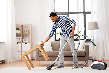 Image showing indian man with vacuum cleaner at home