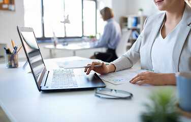 Image showing businesswoman with laptop working at office