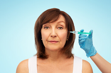 Image showing senior woman and cosmetologist\'s hand with syringe