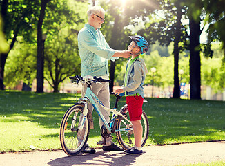 Image showing grandfather and boy with bicycle at summer park